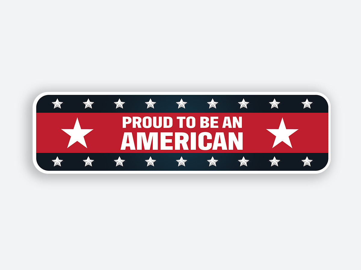 A rectangular patriotic sticker featuring the text “PROUD TO BE AN AMERICAN” in bold white letters on a red background. The design is bordered by a black strip with silver stars on both the top and bottom, with large white stars on either side of the main text, emphasizing the patriotic theme.